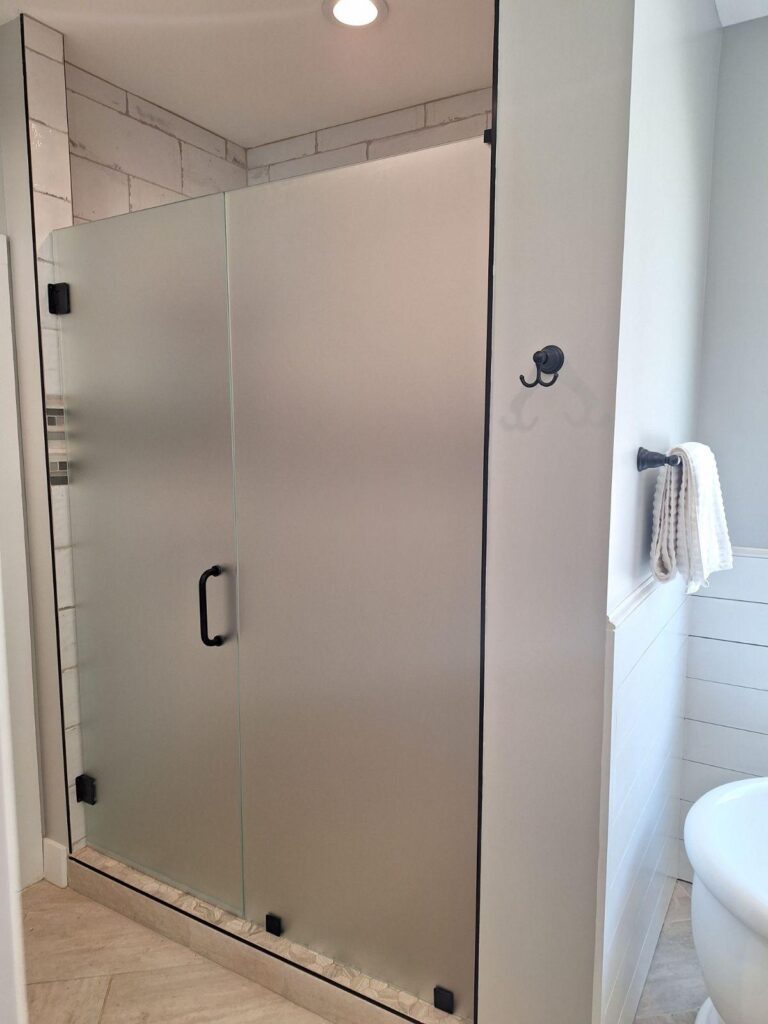 Frosted glass shower enclosure providing privacy while allowing natural light into the bathroom.